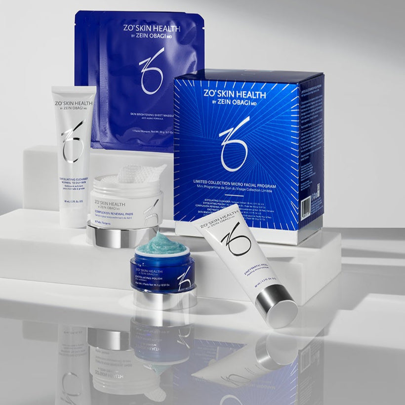 Cosmetic products including jars and boxes on a reflective surface with a neutral background